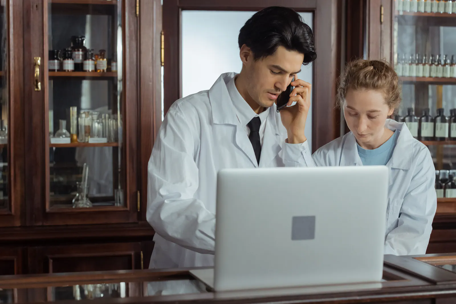 Pharmacy professionals working with digital systems